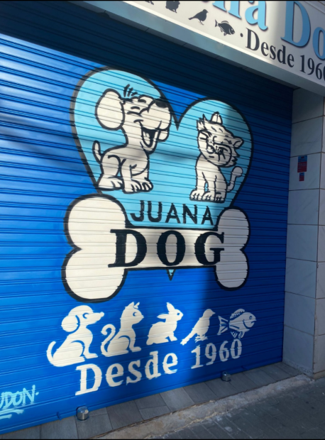Graffiti de logotipo para la tienda Juana Dog en Badalona, pintado a mano sobre persiana metálica de negocio.